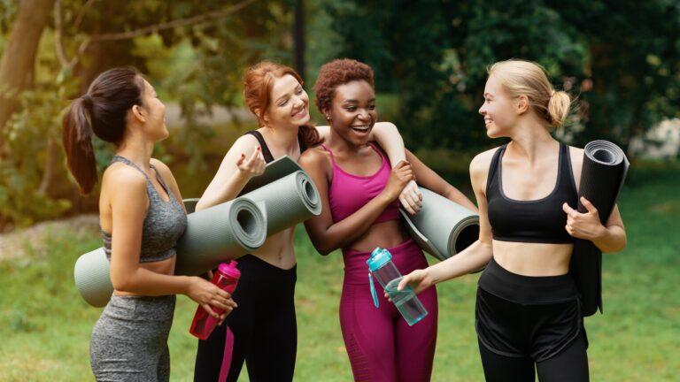 Millennial Girls of Different Races Communicating after Yoga Class Outdoors