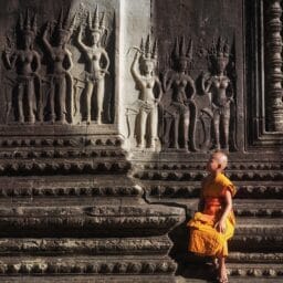 Angkor Wat wall and young buddhist monk